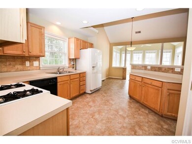 Open-concept kitchen features a breakfast bar that