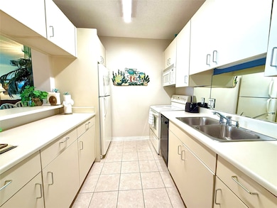 Kitchen open to dining and living room.