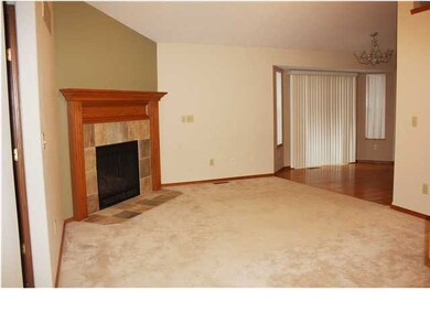 Living room with fireplace. Open floor plan with v