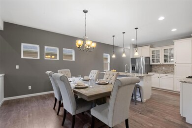 Lots of room to entertain in the open dining room with durable and easy-care laminate plank floors!