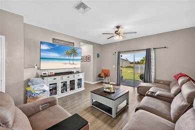 Living room with wood finished floors and a ceiling fan