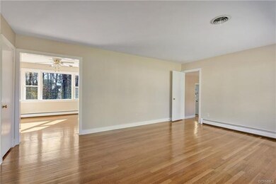 Large Living Room with fresh neutral paint, large picture window, and beautiful hardwoods