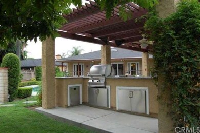 Outdoor cook area under beautiful pergola patio.