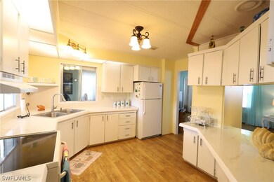 Kitchen featuring white fridge, light wood-type fl