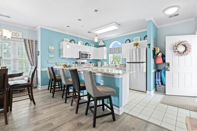 Kitchen with white cabinetry, a wealth of natural 