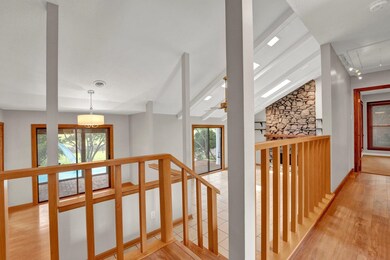 Corridor with lofted ceiling with beams and light 