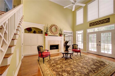 Living Room with Gas Log Fireplace Opens Onto Larg