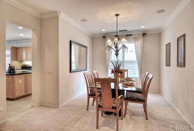 Formal dining with speakers and crown molding