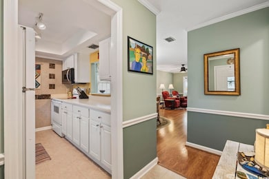 Kitchen featuring white electric range, visible ve
