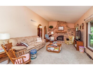 The spacious living room features several furnitur