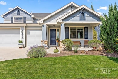 Craftsman-style home featuring covered porch, concrete driveway, a front yard, an attached garage, and stone siding