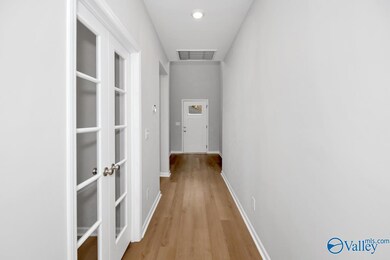 The glass-pane doors lead to the designated office/den