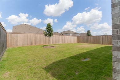 Spacious backyard with a well-maintained lawn, pri