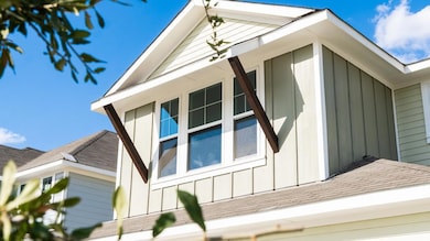View of side of property featuring roof with shin