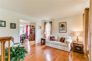 Living Room has lovely crown moulding and opens to
