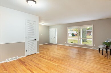 WOW! Step in to this Large and OPEN Living Room and Dining Room combo complete with Beautiful, Newly Refinished Wood Floors, Light and Bright NEW Windows and Freshly Painted Interior!