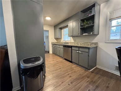 Kitchen featuring light wood-type flooring, open s