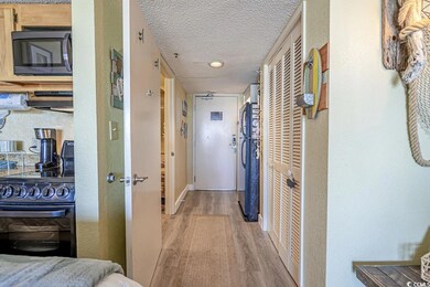 Corridor with light hardwood / wood-style floors a