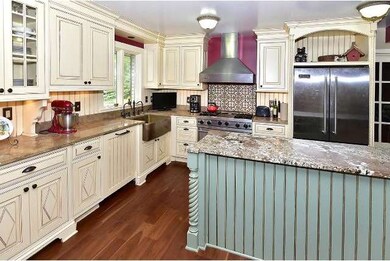 Custom designed sink, cabinets, granite island, an