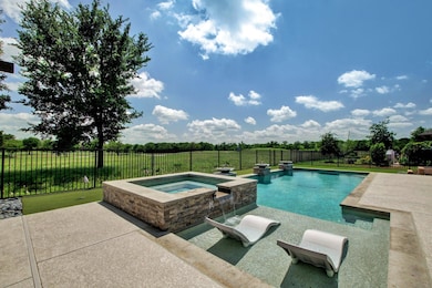View of pool featuring an in-ground hot tub, a fe