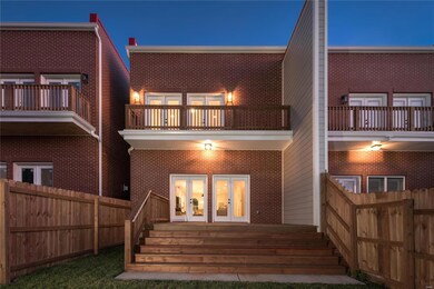 Brick, covered porch, balcony off primary bedroom,