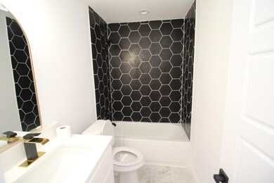 Full bathroom featuring vanity, toilet, and tiled shower / bath