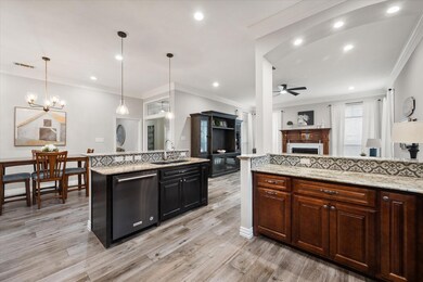 Kitchen featuring a kitchen island, ceiling fan wi