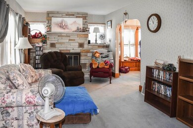 Living room with a fireplace and archways to the d