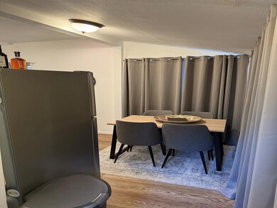 Dining space featuring lofted ceiling, wood-type f