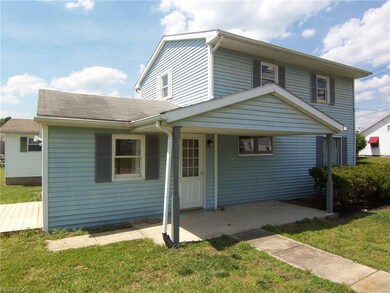 10th Ave. side of home with covered patio and side