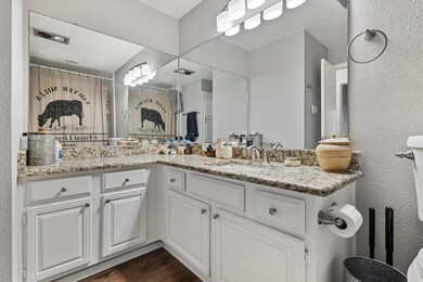 Bathroom featuring vanity and wood-type flooring