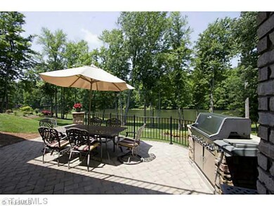Exterior Back. Cook out with some friends on this lovely patio while you watch the sunset over the lake!