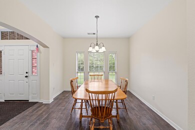 Dining room with a chandelier, dark wood-type flo