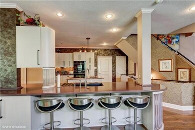 A breakfast bar on one side of the kitchen counter