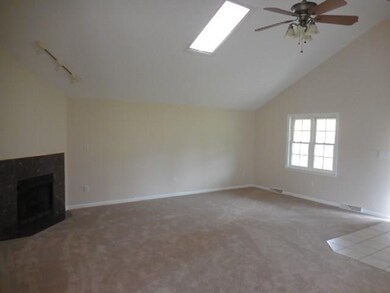 LIVING ROOM WITH FIREPLACE & SKYLIGHT