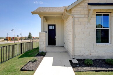 Property entrance with stone siding, a shingled r