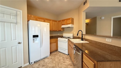 Kitchen featuring white appliances, under cabinet