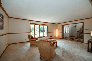 Spacious room has chair rail, crown molding and bo