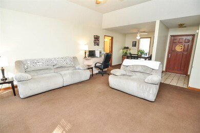 The large living room features vaulted ceilings wi