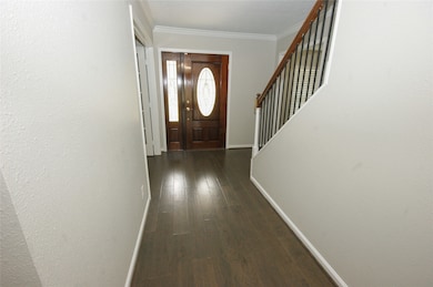 WOOD FRONT DOOR AND WROUGHT IRON RAILS