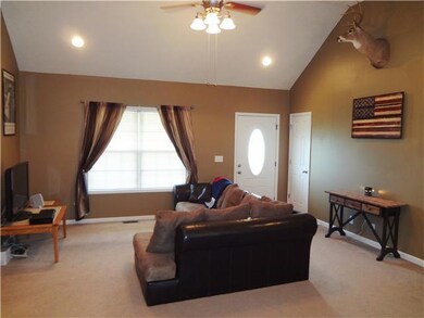 Another view of the living room. Also notice the recessed lights and nice ceiling fan. 