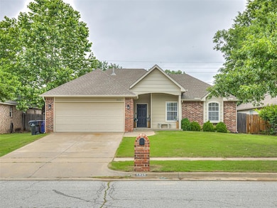 Single story home featuring concrete driveway, an attached garage, and brick siding