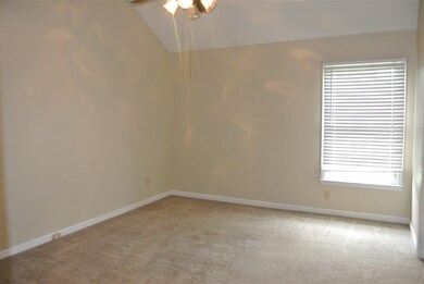 Spacious master bedroom with ceiling fan and walk 