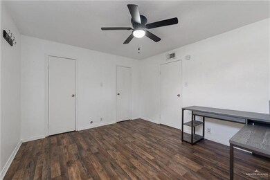 Spare room featuring dark hardwood / wood-style floors and ceiling fan