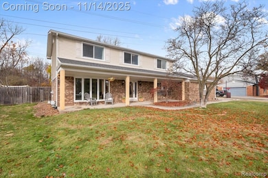 Traditional-style house with brick siding and covered porch