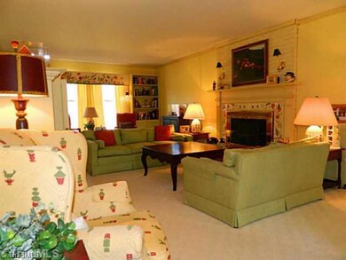 Living Room. Living room features wood burning fireplace, crown moulding and chair railing