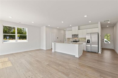 Kitchen with stainless steel appliances, healthy amount of natural light, tasteful backsplash, light countertops, and recessed lighting