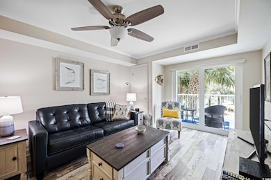 Living room featuring ceiling fan, crown molding, 