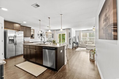 Kitchen with an island with sink, dark brown cabin