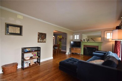 Hardwood floored living room featuring a fireplace